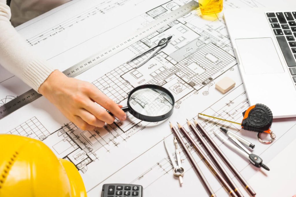 Holstic Technoengineers Private Limited || Construction || Infrastructure || person using magnifyer scaled 1